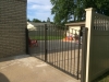 Custom Wrought Iron Arched Gate, Tan Vinyl Closed Picket Fence-See Vinyl Fence and Iron Gates Categories.