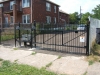 Cantilever Iron Gate Bowed Across the Top with Gate Operator