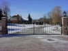 Custom Wrought Iron Arched Double Driveway Gate with Gate Operator and Finial Design